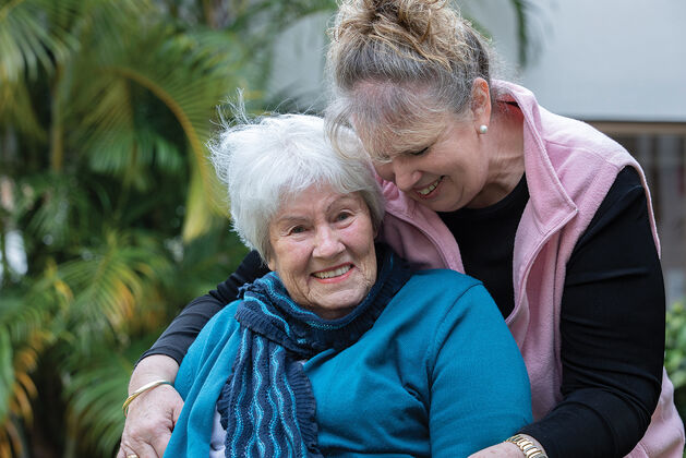 an elderly aged care resident with aged care worker at baptistcare shalom centre aged care home in macquarie park nsw