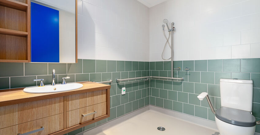 large ensuite bathroom for elderly aged care resident in baptistcare caloola centre residential aged care home