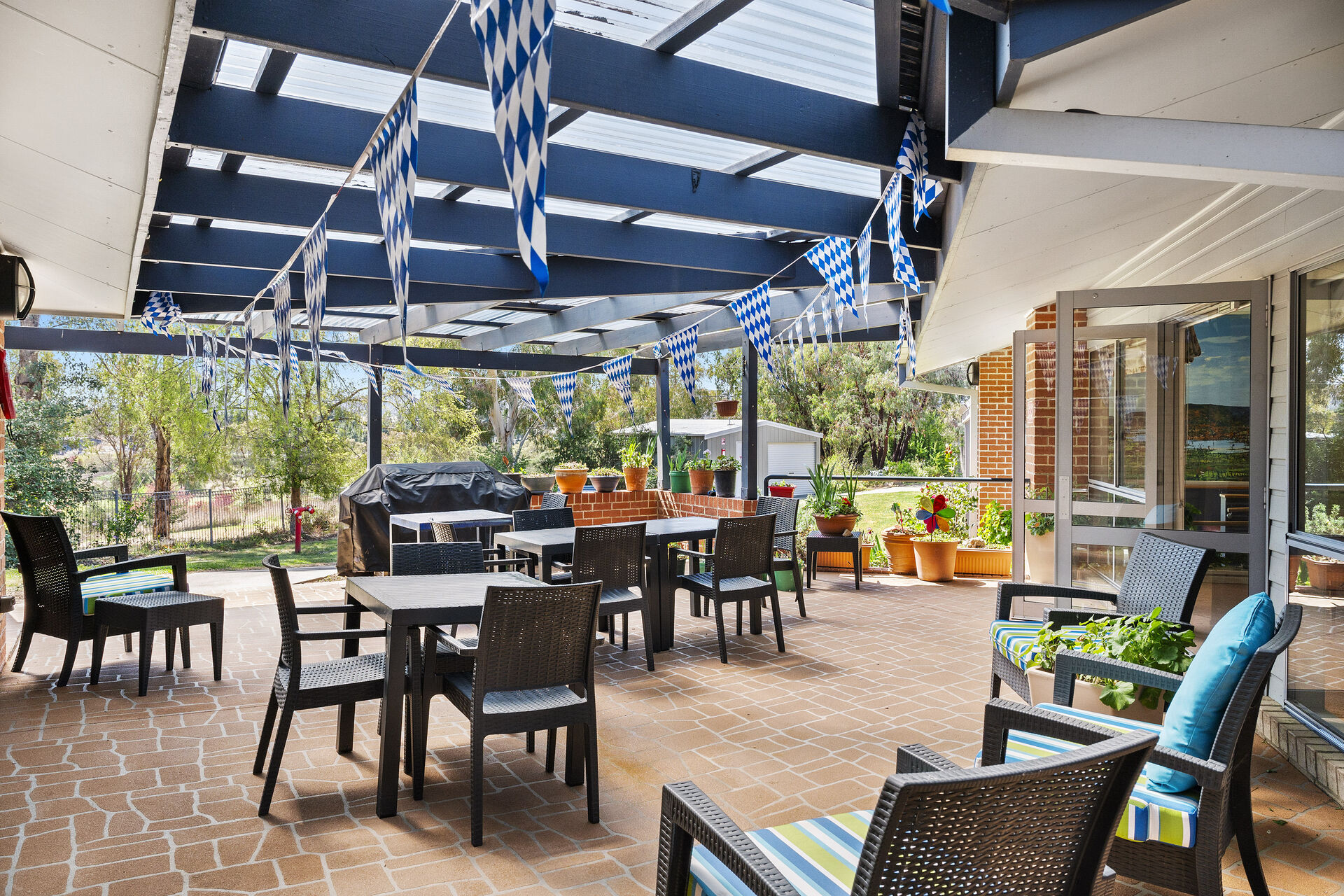 spacious outdoor sitting area under an awning of george forbes aged care home with dementia care in Queanbeyan nsw