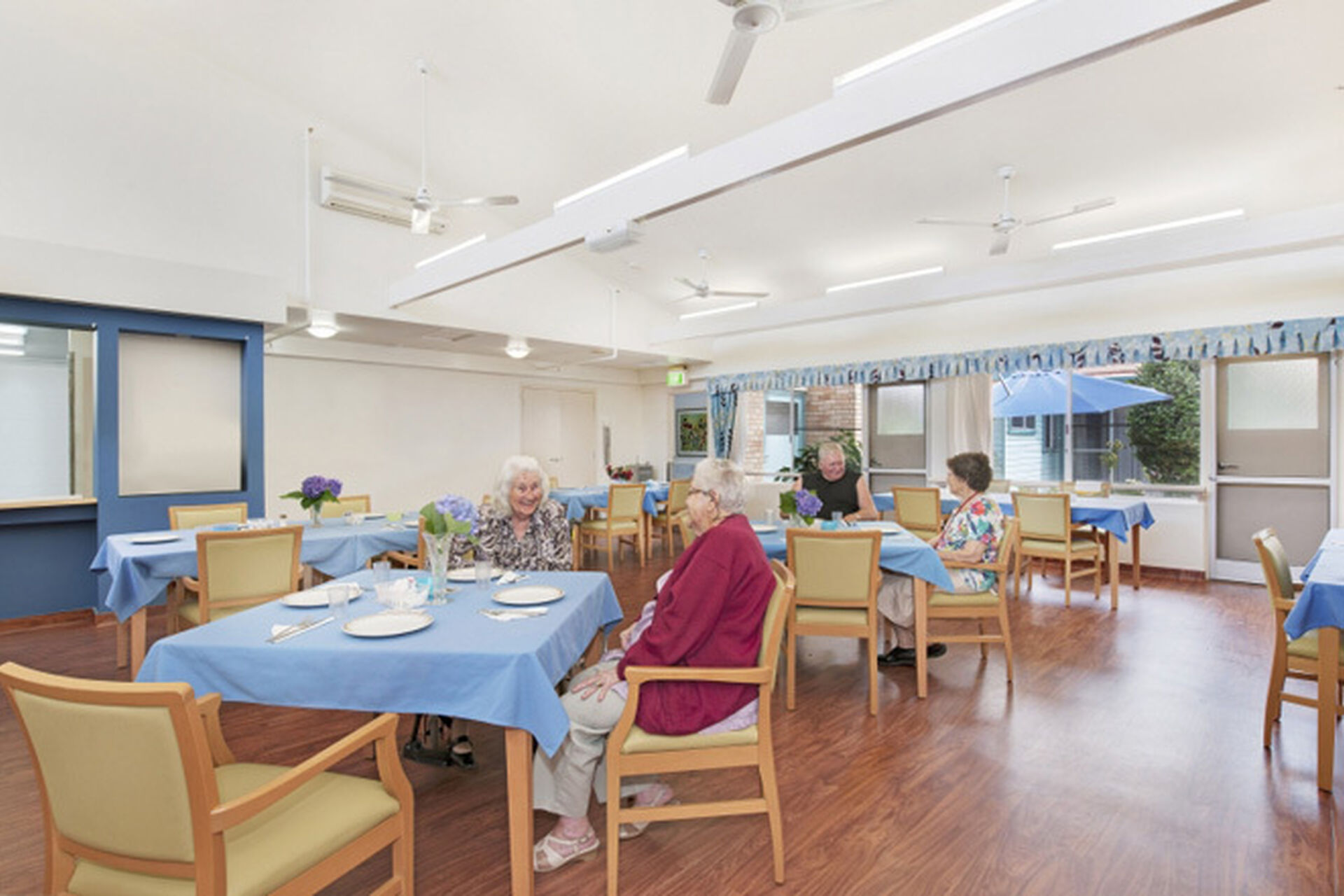 aged care residents sitting and socialising in the spacious dining room at baptistcare maranoa centre aged care home in alstonville nsw far north coast