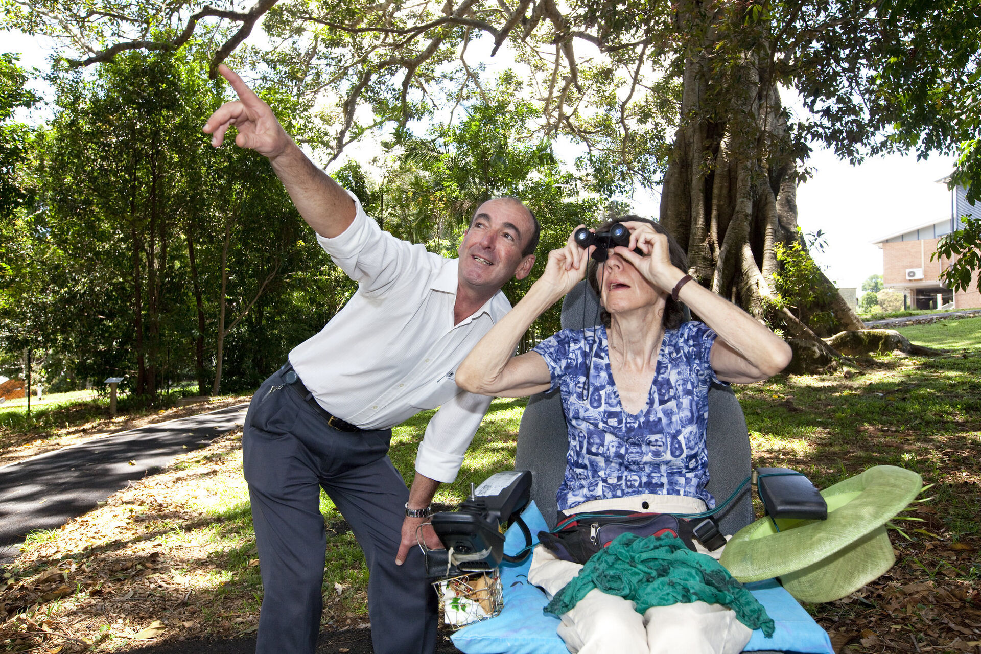 an aged care resident and aged care worker enjoying the sights outside with binoculars at baptistcare maranoa centre aged care home in alstonville nsw far north coast